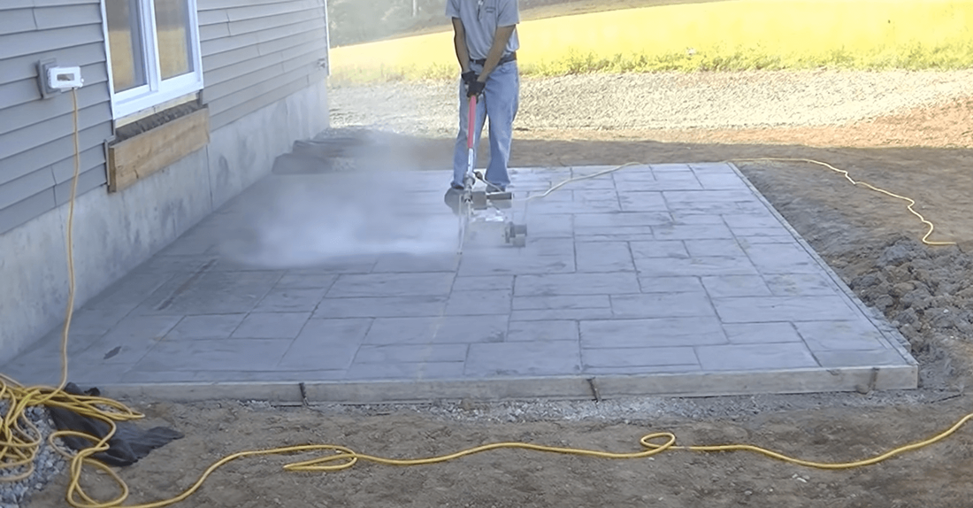 Cutting expansion joints into new concrete slab for stamped concrete patio